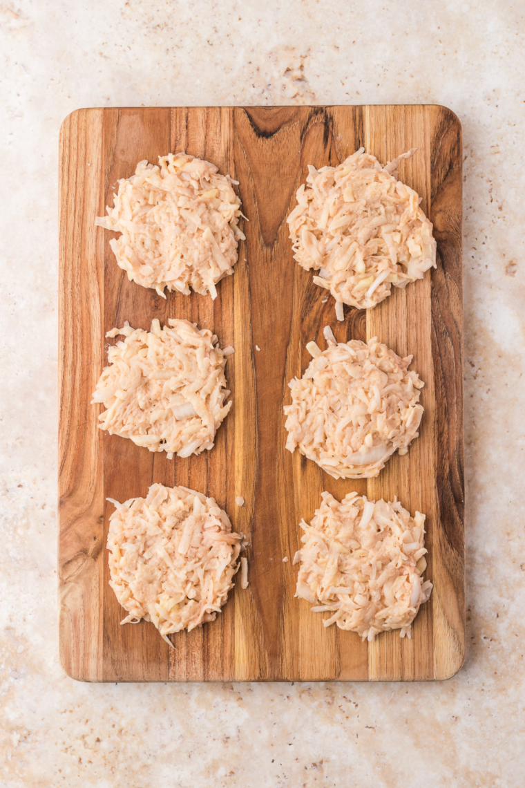 hands forming latke patties and pressing out liquid
