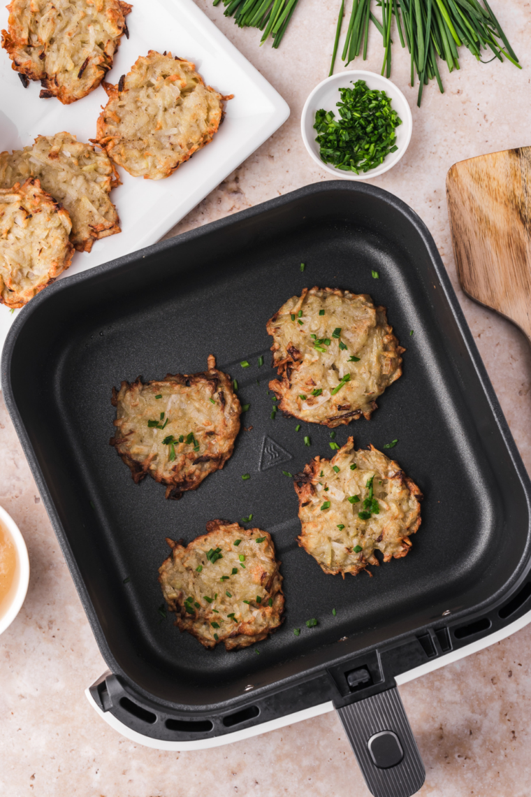air fryer latkes flipped and sprayed with cooking oil