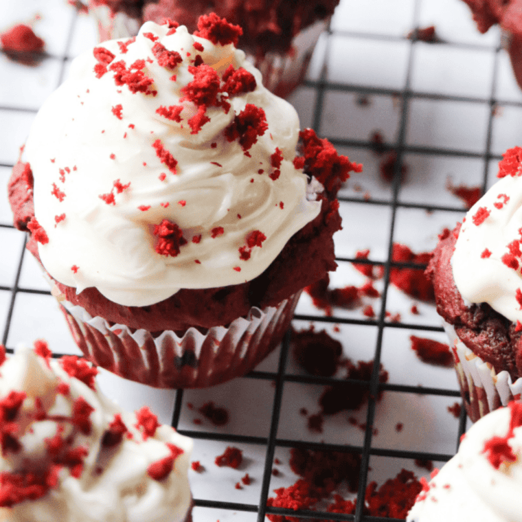 Golden-baked Air Fryer Red Velvet Cupcakes with smooth cream cheese frosting and bright red interior.