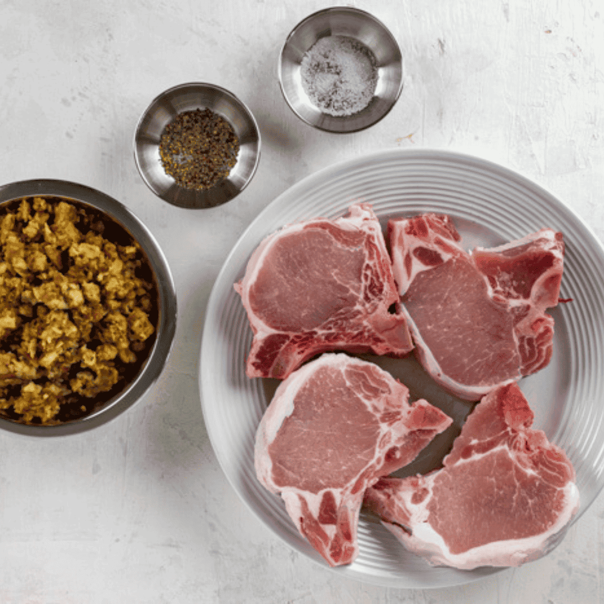 Ingredients needed for Air Fryer Stuffed Boneless Pork Chops on kitchen table.