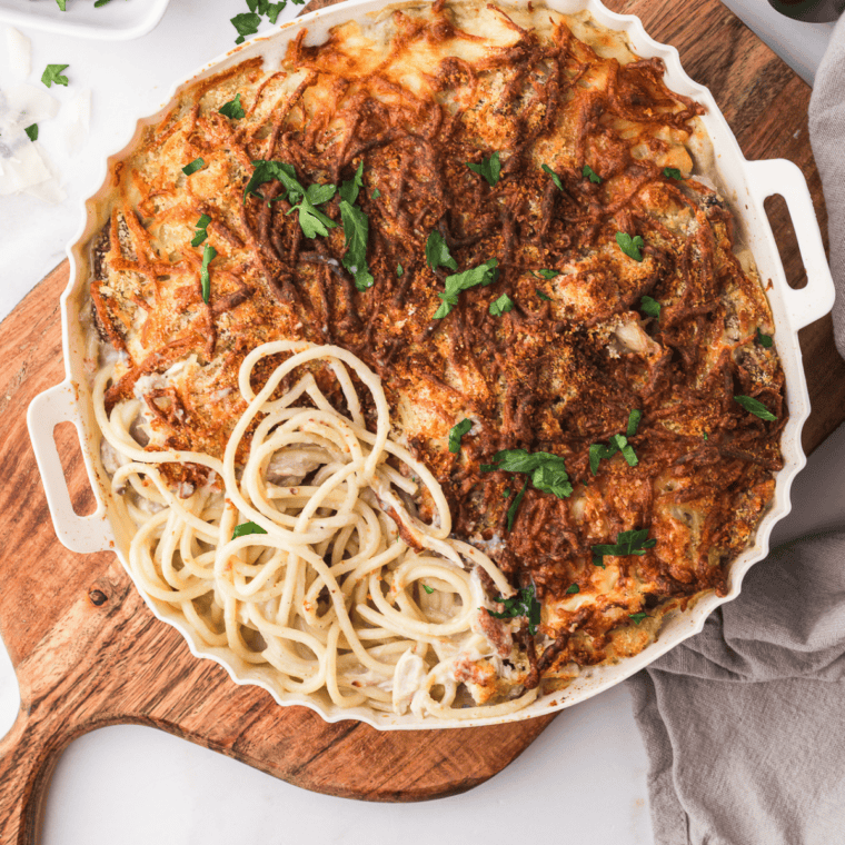 Air Fryer Turkey Tetrazzini topped with parmesan cheese, cherry tomatoes, and fresh basil before serving.