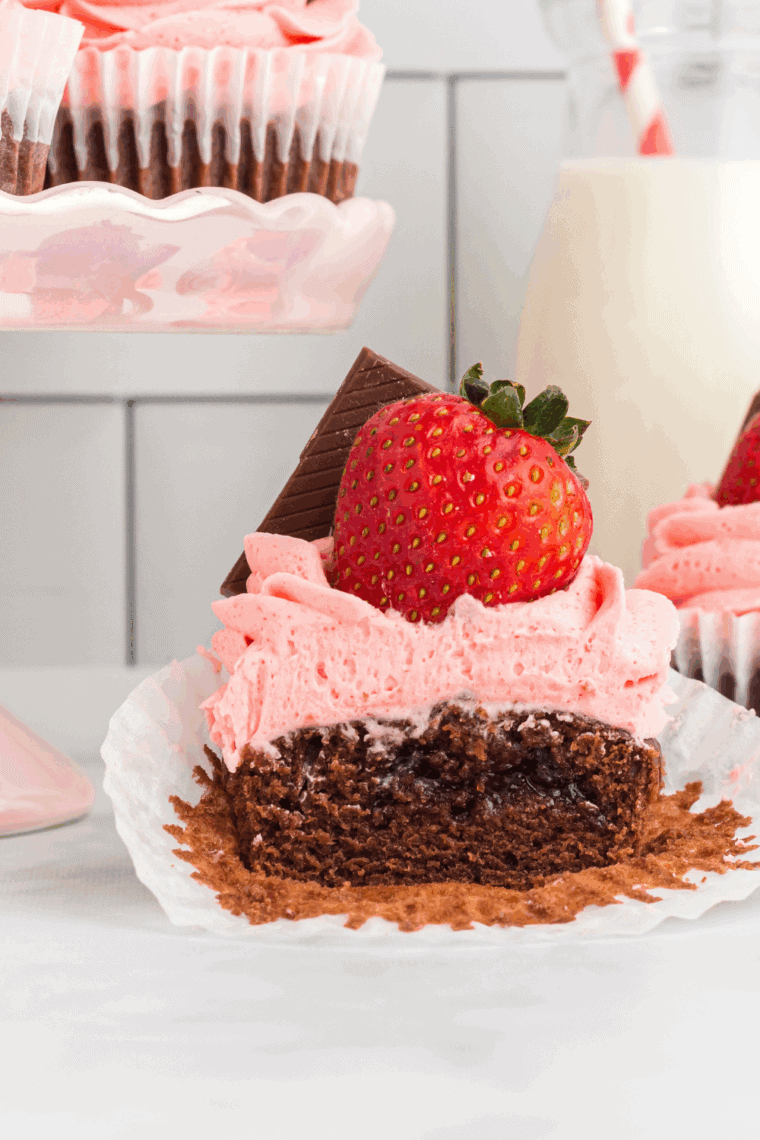 Air fryer Valentine cupcakes with pink and red frosting, decorated with sprinkles for Valentine’s Day.