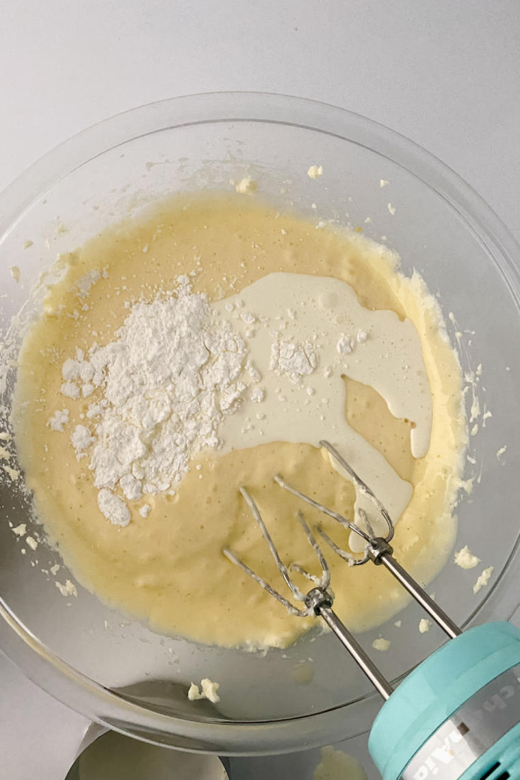 Low speed mixing cream cheese sugar and flour until glossy cheesecake batter