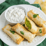 golden crispy air fryer avocado egg rolls with creamy avocado filling