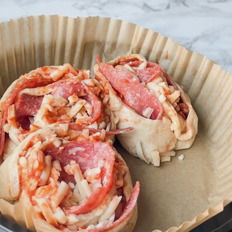 Place pizza rolls into the air fryer basket.