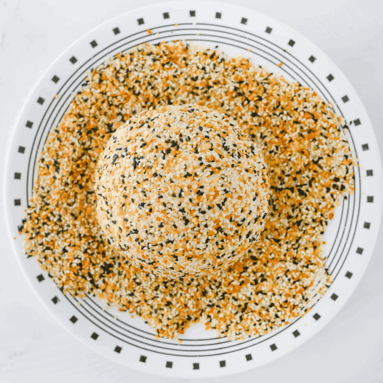 Sprinkle the everything seasoning over the top of the cheeseball, covering.