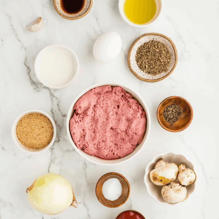 Ingredients needed for Meatloaf without Eggs on kitchen table.