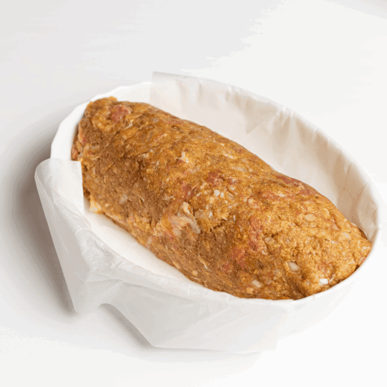 Shaping meatloaf into loaf pan and pressing gently.