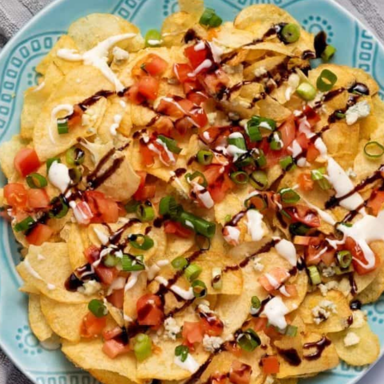 "Delicious Air Fryer Ultimate Potato Chip Nachos topped with melted cheese, jalapeños, and bacon, served on a platter."