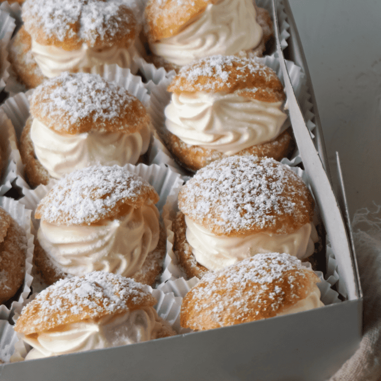 Golden brown Air Fryer cream puffs filled with creamy filling, fresh out of the air fryer.