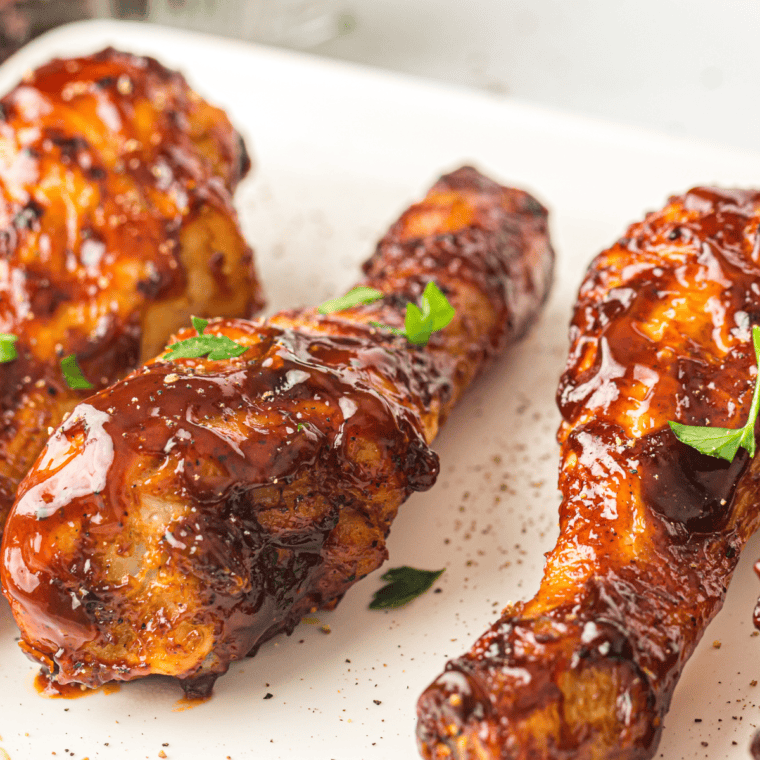 Crispy and saucy Air Fryer BBQ Chicken Legs served on a plate, coated in a rich barbecue glaze.