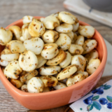 Homemade air fryer corn nuts golden and crispy in white bowl on wooden tabl