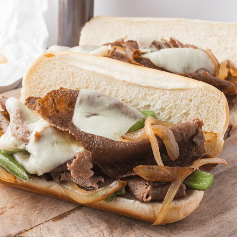 Air Fryer Steak Umms cooking in the basket with melted provolone cheese.