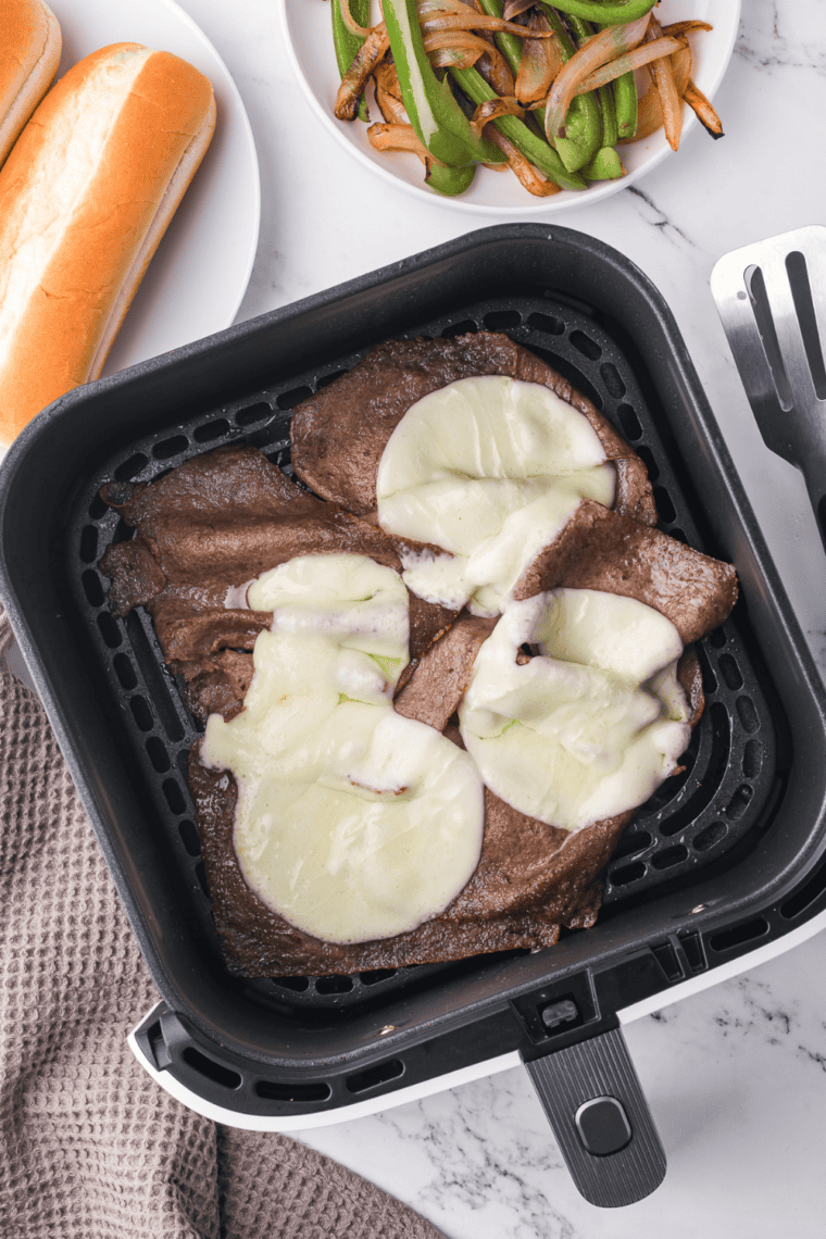 Air Fryer Steak Umms cooking in the air fryer basket, perfectly crisped and ready to serve.