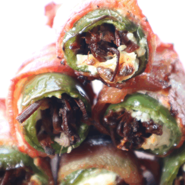 Air Fryer Texas Twinkies with bacon-wrapped jalapeños stuffed with brisket and creamy cheese on a serving platter.