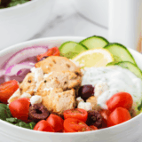 Small bowl of creamy homemade Arby’s Tzatziki Sauce garnished with fresh dill and cucumber slices