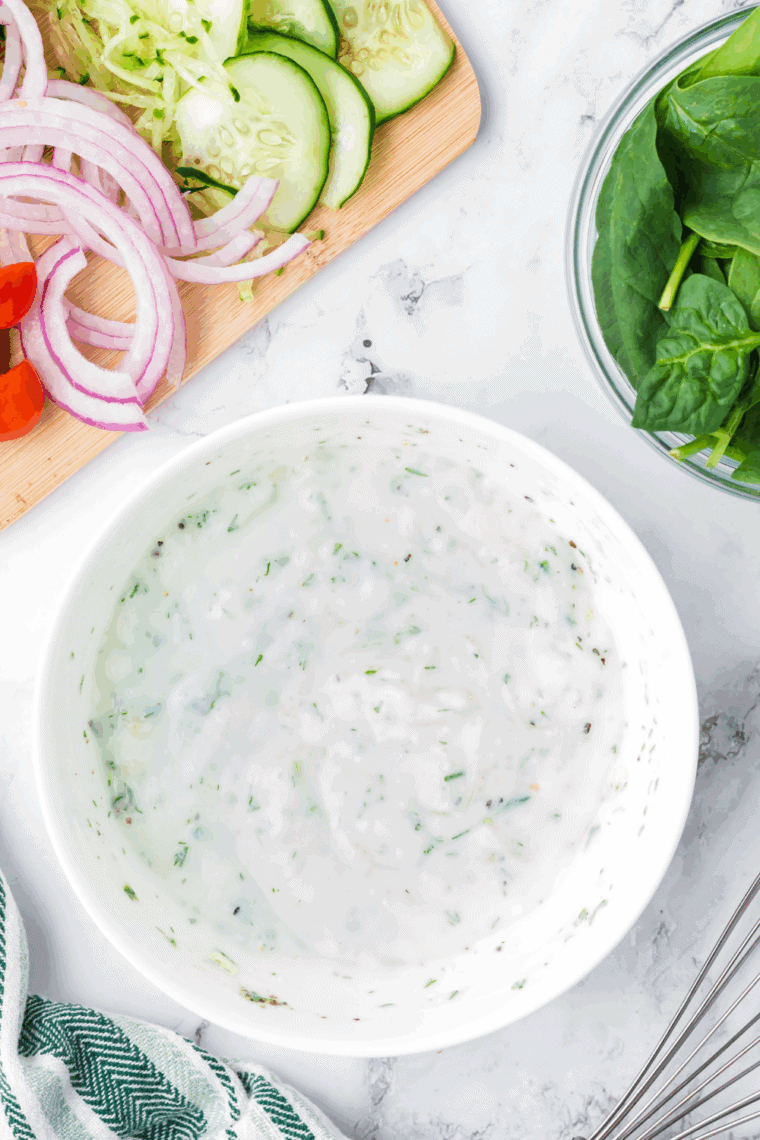 Homemade Arby’s Tzatziki Sauce in a bowl garnished with fresh dill and cucumber slices
