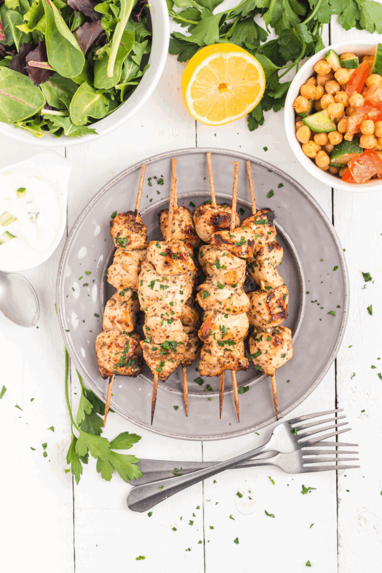 Air Fryer Cilantro Lime Chicken Skewers cooked to golden perfection, garnished with fresh cilantro and lime wedges.
