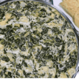 A bowl of creamy Instant Pot Copycat Applebee’s Spinach and Artichoke Dip, ready to serve with chips or bread for dipping.