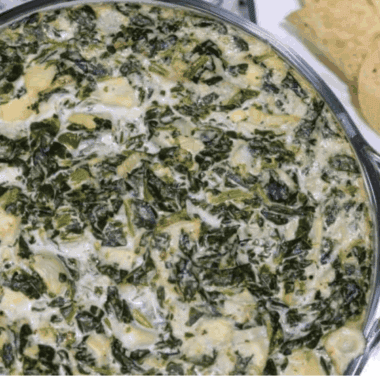 A bowl of creamy Instant Pot Copycat Applebee’s Spinach and Artichoke Dip, ready to serve with chips or bread for dipping.