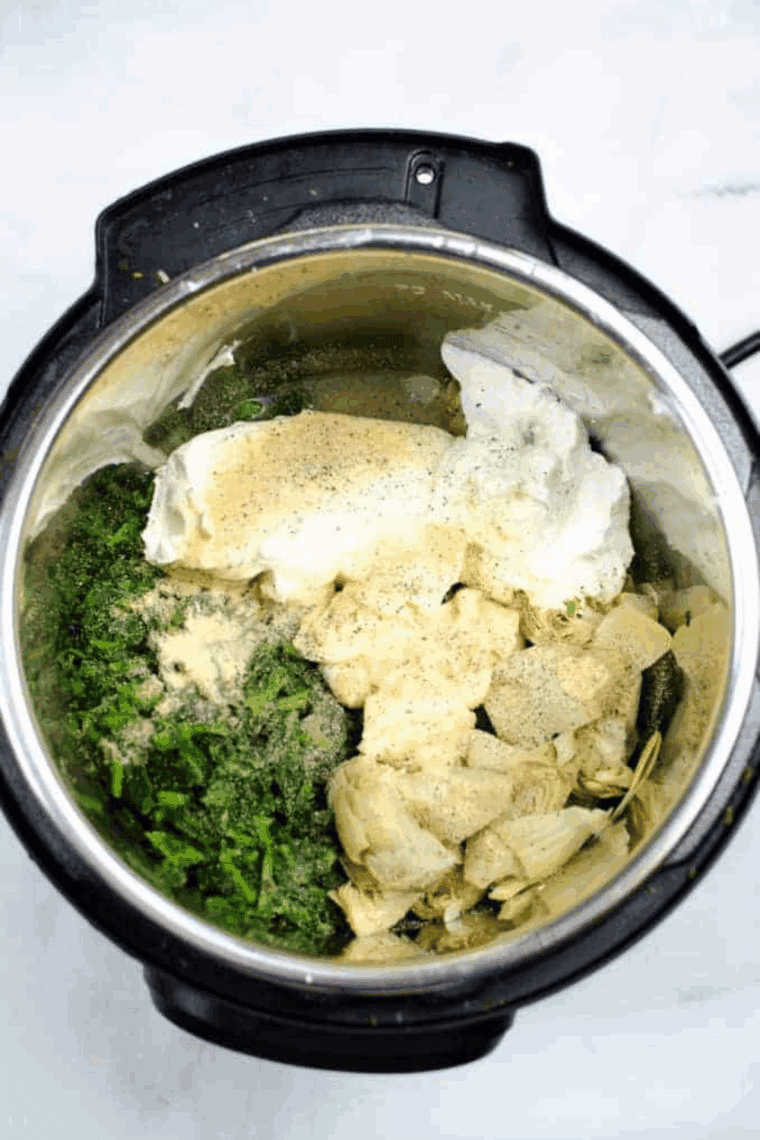 Adding chopped spinach, artichoke hearts, cream cheese, sour cream, and seasonings into the Instant Pot, mixing everything together for a creamy dip.