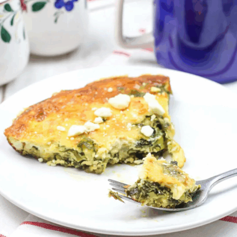 Air fryer asparagus, spinach, and cheese frittata in a skillet, golden brown and ready to serve.