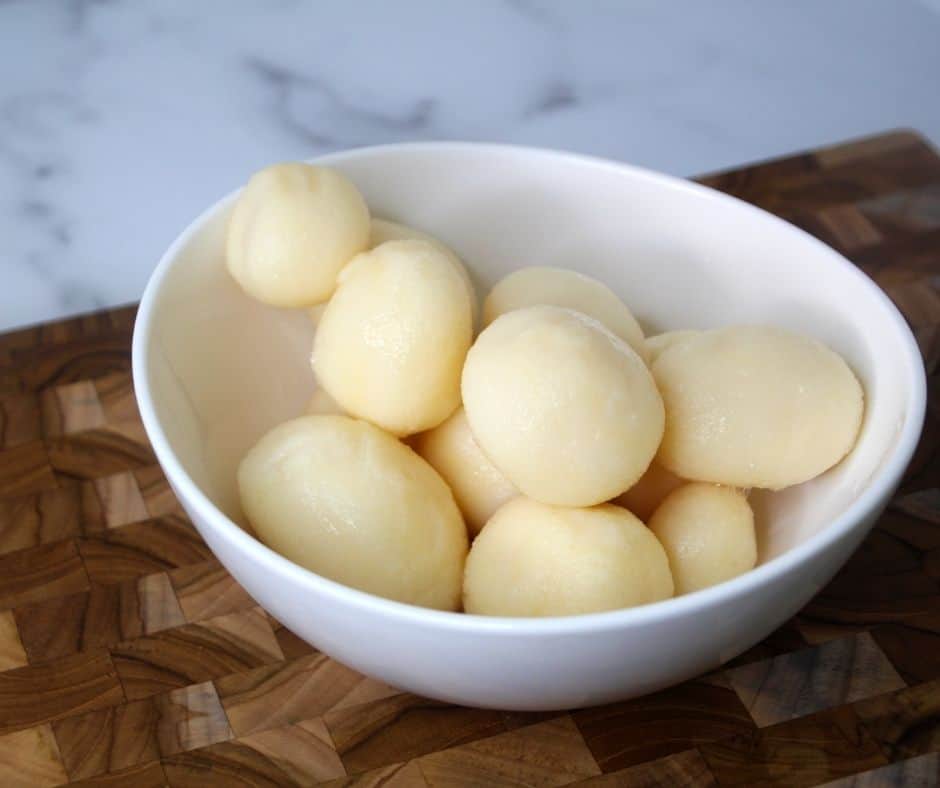 Uncooked air fryer canned potatoes in a white serving bowl. 