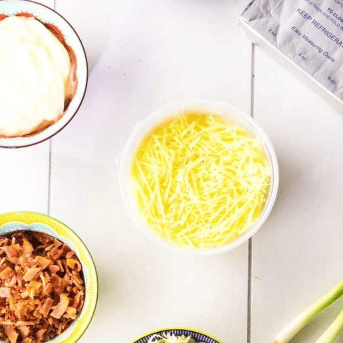 Ingredients needed for Air Fryer Cottage Cheese Dip on kitchen table.