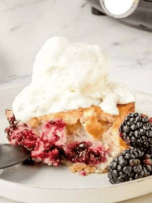 Delicious Air Fryer Blackberry Cobbler served on a plate with a golden biscuit topping and juicy blackberries.