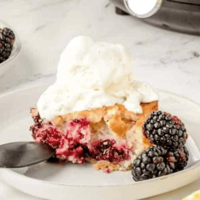 Delicious Air Fryer Blackberry Cobbler served on a plate with a golden biscuit topping and juicy blackberries.