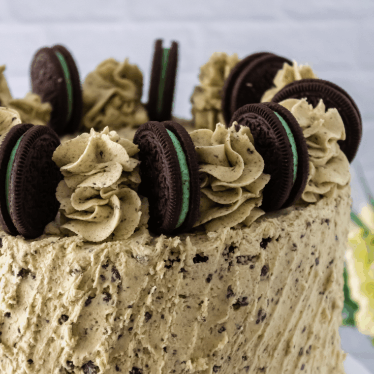 Frosted cake with Oreos on table, decorated.