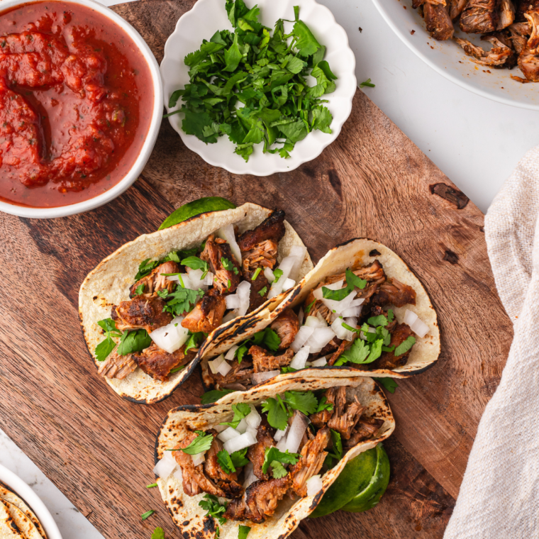 Soft flour tortilla filled with shredded pork carnitas and fresh cilantro