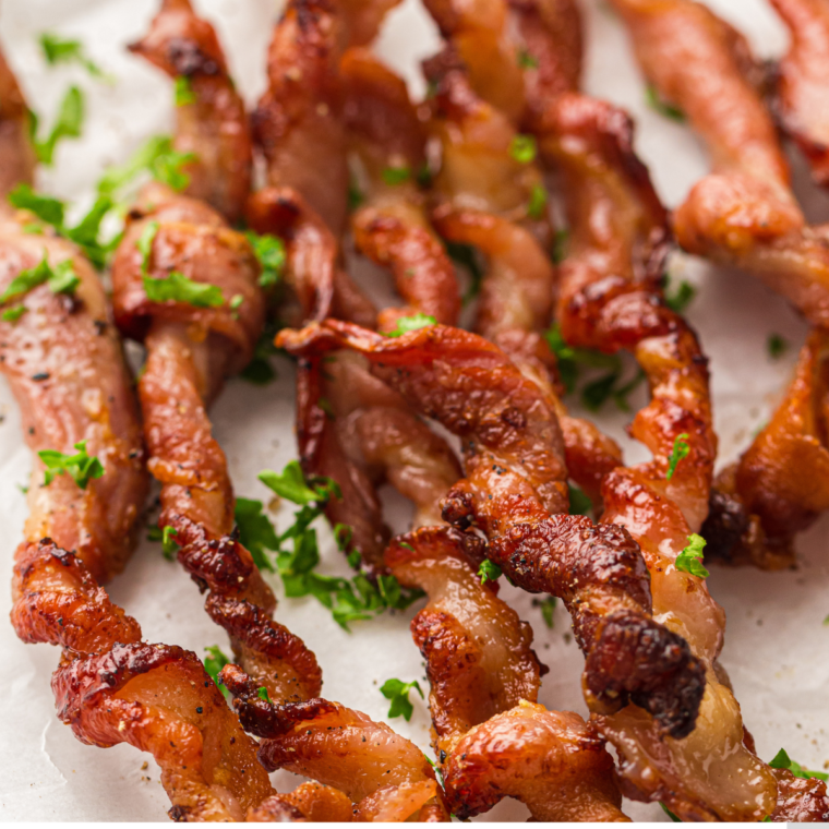 Plate of crispy Air Fryer Twisted Bacon strips arranged neatly, showcasing their golden-brown, crunchy texture.