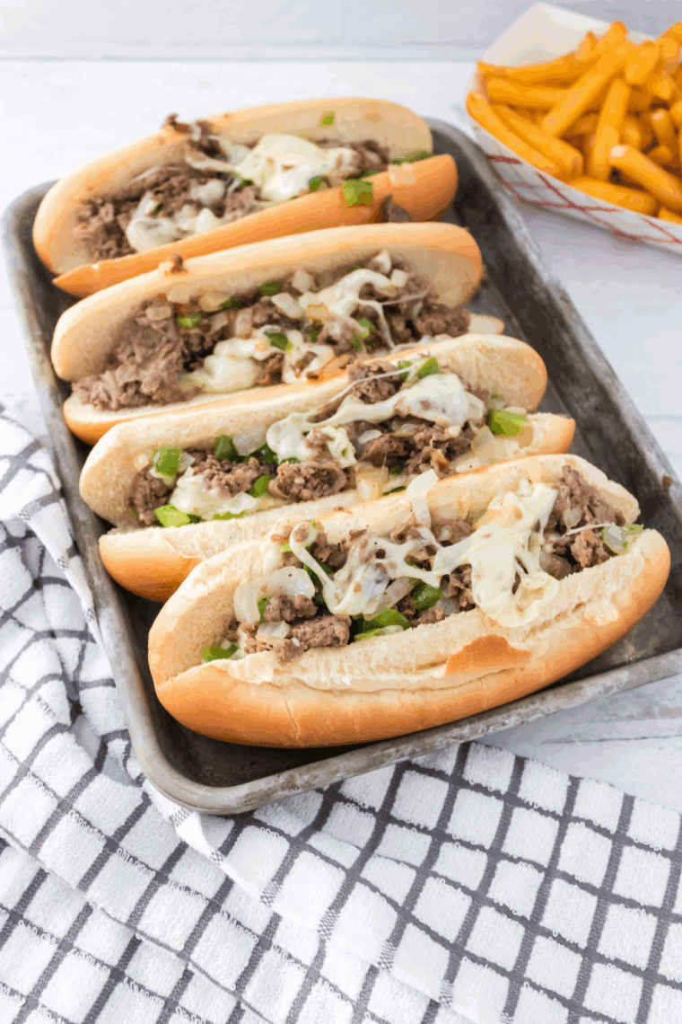 Homemade Arby’s Angus Cheesesteak with ribeye, melted provolone, sautéed onions, and peppers on a toasted hoagie roll.