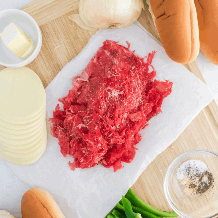 Seasoning thinly sliced ribeye and mixing garlic butter.