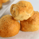 Golden air fryer bacon-wrapped cheese bombs with melty cheese inside