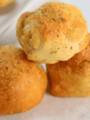 Golden air fryer bacon-wrapped cheese bombs with melty cheese inside