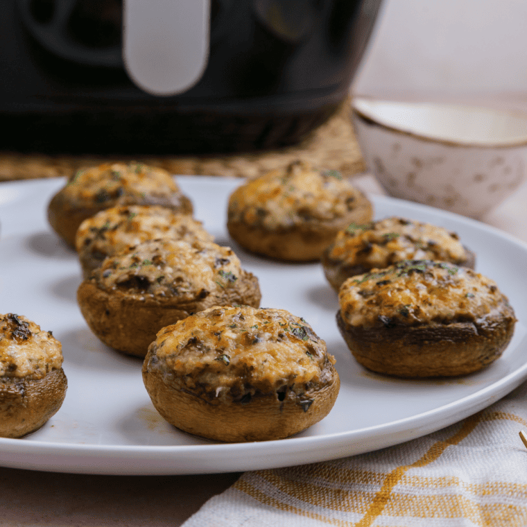 Close-up of Longhorn Stuffed Mushrooms with golden brown crispy topping and melted cheese.