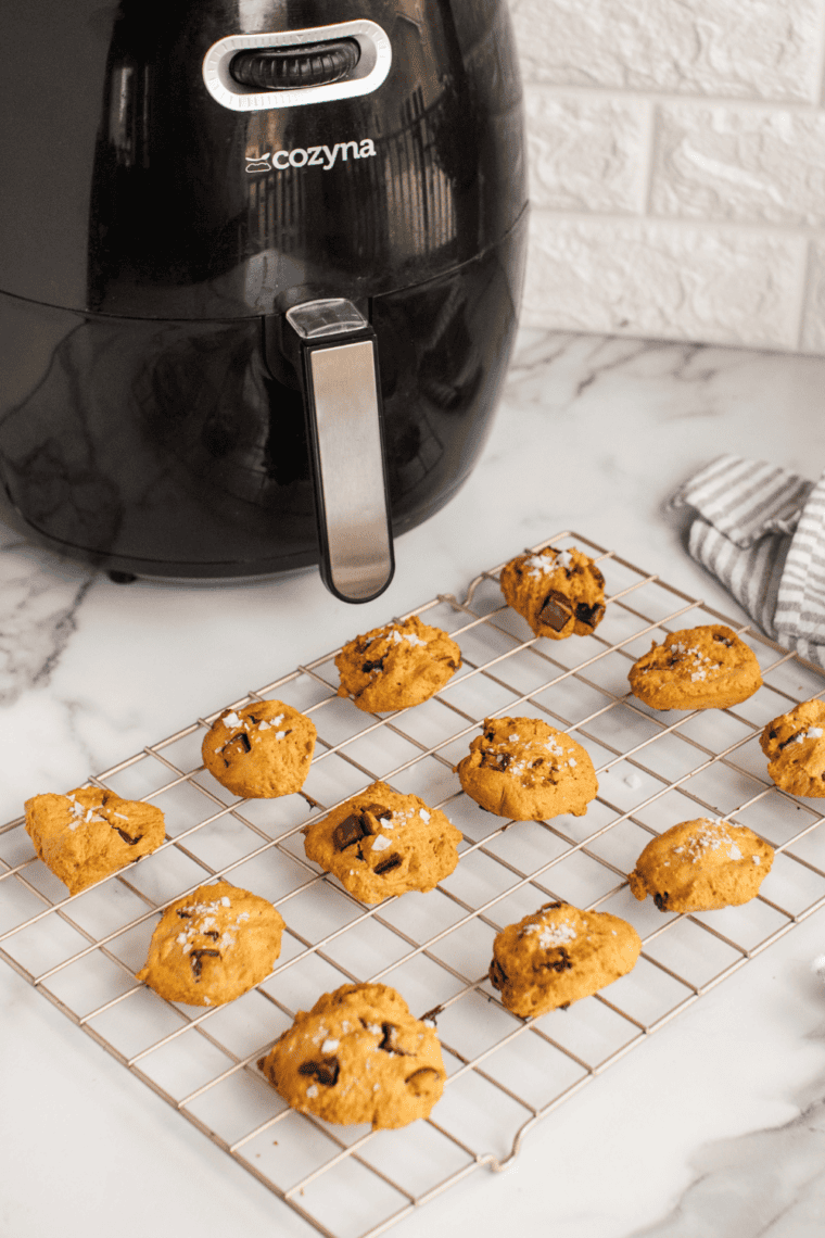 Pumpkin chocolate chunk sandwich cookies fresh from the air fryer, soft, spiced, and filled with creamy chocolate-filled centers.