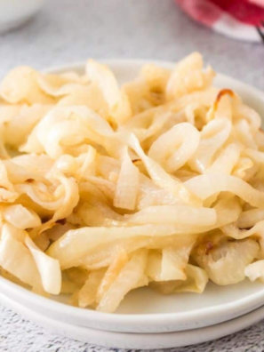 Air fryer caramelized onions, soft and deep golden brown, in a white bowl