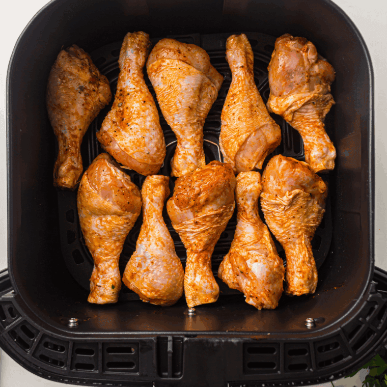Place Easy Air Fryer Garlic Parmesan Chicken Legs into the air fryer basket.