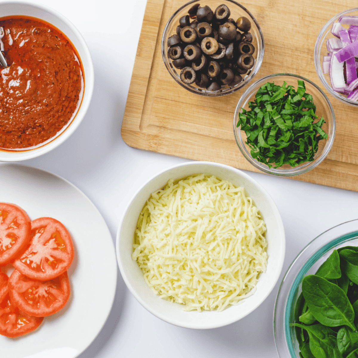 Ingredients needed for Air Fryer Puff Pastry Pizza on kitchen table.