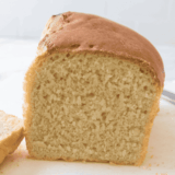 freshly baked soft farmhouse white sandwich bread on a cutting board