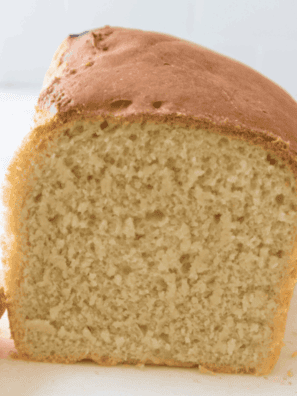 freshly baked soft farmhouse white sandwich bread on a cutting board