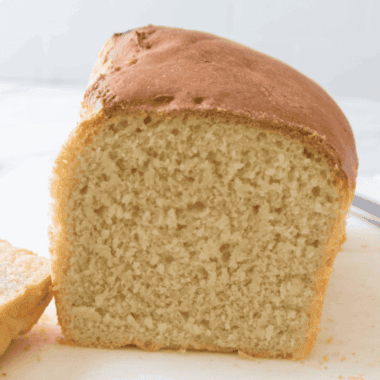 freshly baked soft farmhouse white sandwich bread on a cutting board