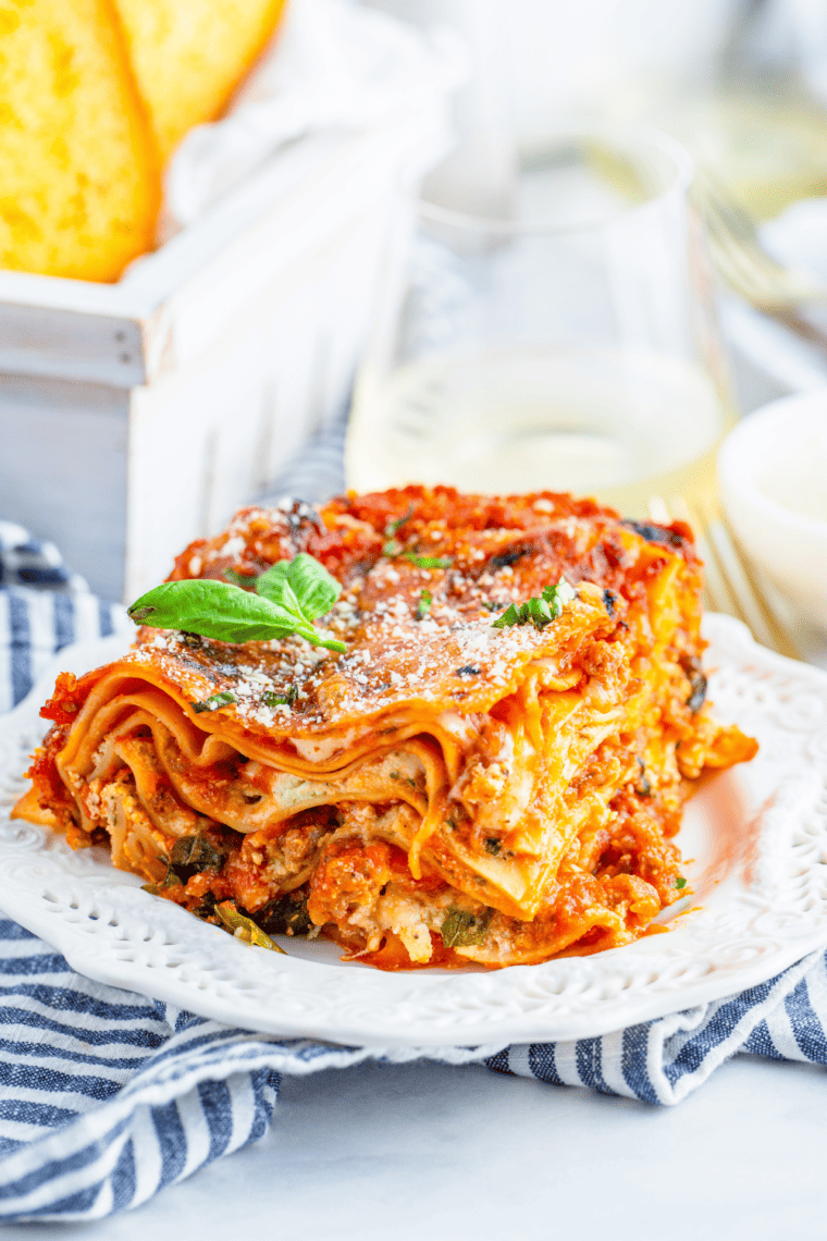 side view closeup: a large slice of lasagna in air fryer on a plate