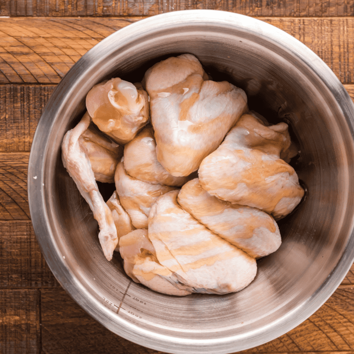 Pat chicken wings dry and toss with salt and cornstarch to help them crisp in the air fryer or oven.