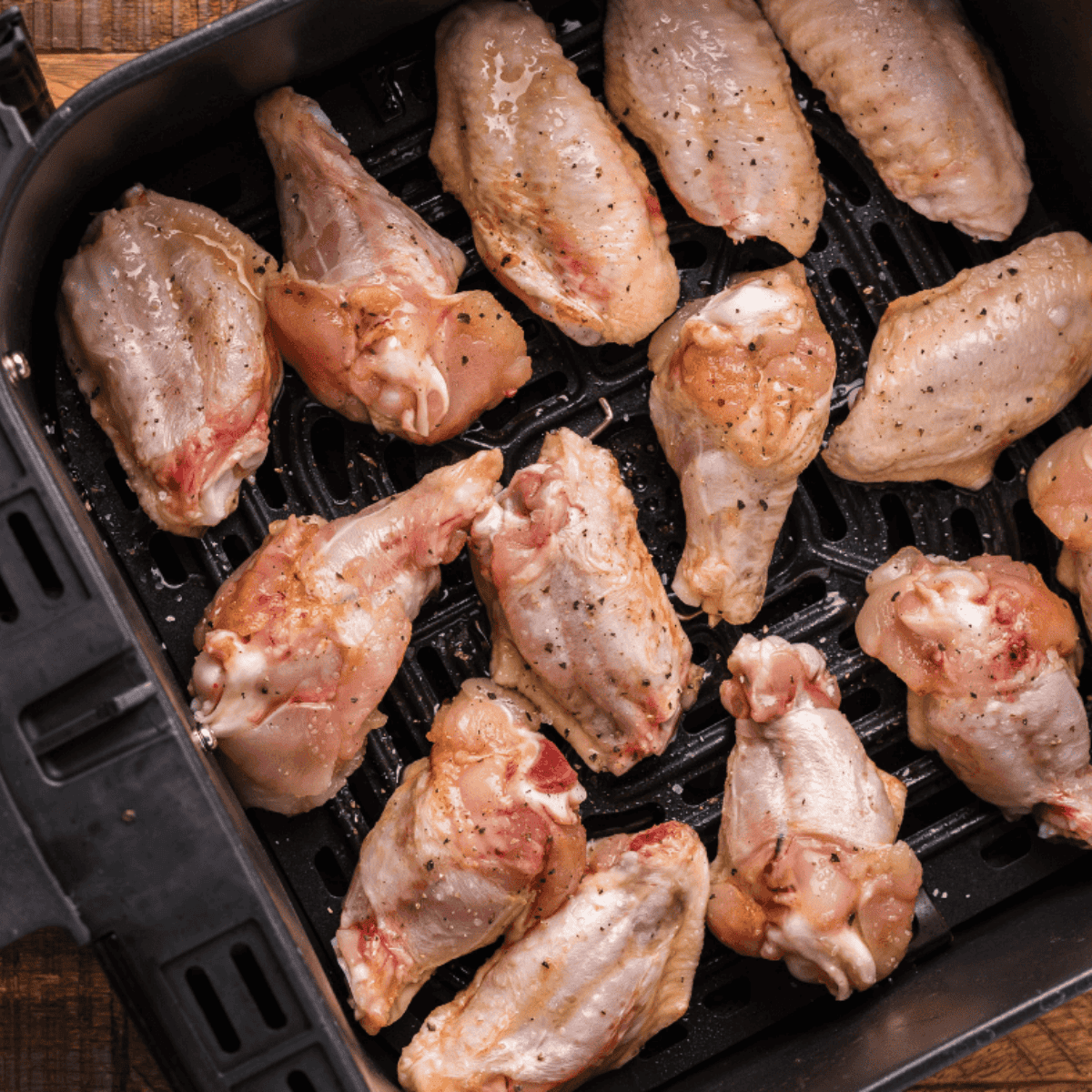Arrange wings in an air fryer basket or on an oven rack and cook until golden and crispy, flipping halfway through.