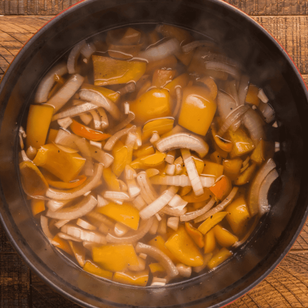 Simmer mango nectar, habanero peppers, honey, and seasonings in a saucepan until thick and flavorful.