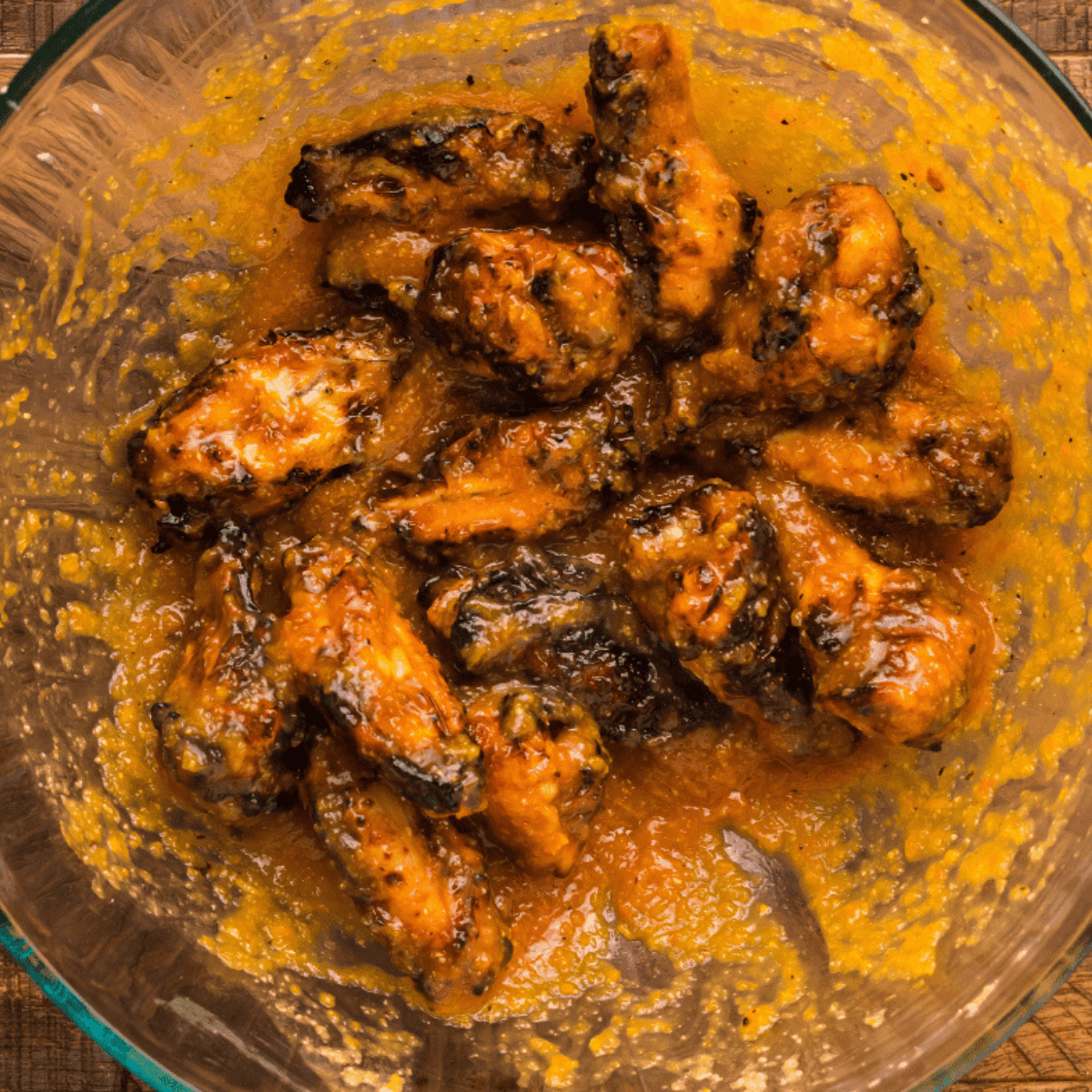 Coat the crispy cooked wings in the homemade mango habanero sauce for a bold, spicy-sweet flavor.